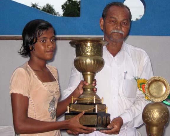 Niharika Patel receives the trophy as the best woman swimmer of the State championship in Bhubaneswar on June 7, 2010.