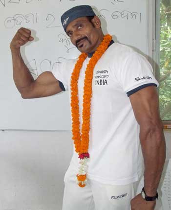 Orissa``s Kartikeswar Jena shows his bicep in Bhubaneswar on July 14, 2008 before leaving for the Asian Bodybuilding Championship to be held at Hong Kong from July 16-21.