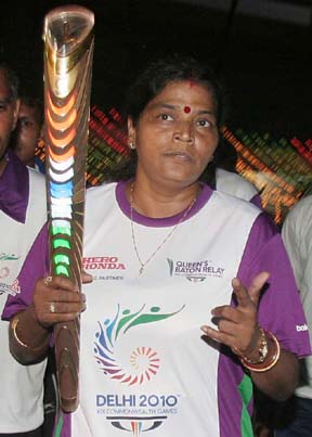 Orissa cyclist Minati Mohapatra runs with the Queeen`s Baton for the Delhi Commonwealth Games, in Bhubaneswar on August 9, 2010.