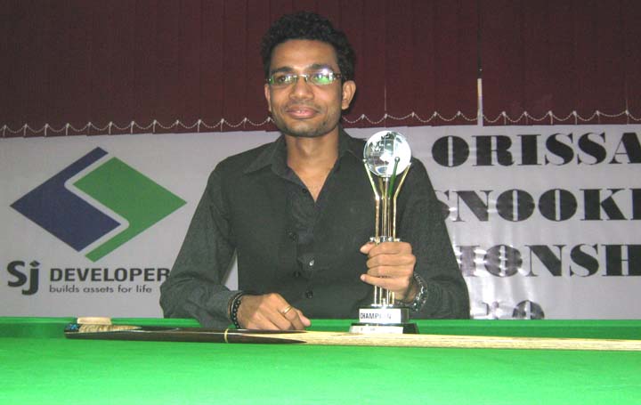 Rakesh Roshan Pradhan with the trophy after winning the SJ Cup Snooker Tournament in Bhubaneswar on August 14, 2010.