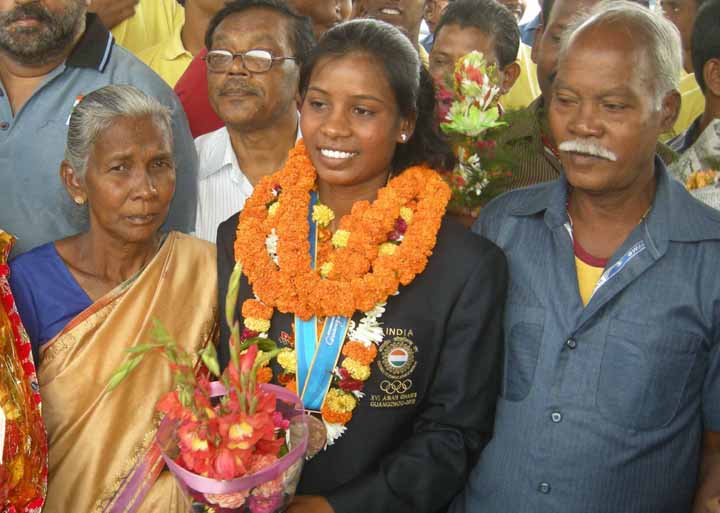 Asiad rowing bronze medallist Pramila Prava Minz with her parents at Cuttack on November 23, 2010.