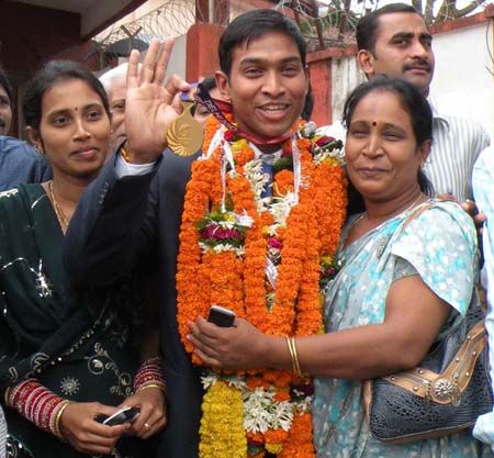 Commonwealth Games gold medallist K Ravi Kumar is greeted by his mother and sister at Bhubaneswar in 2010.