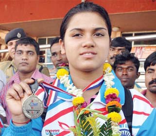 Orissa lifter Subhasmita Mohanty displays her Commonwealth medals in Bhubaneswar on October 18, 2011.