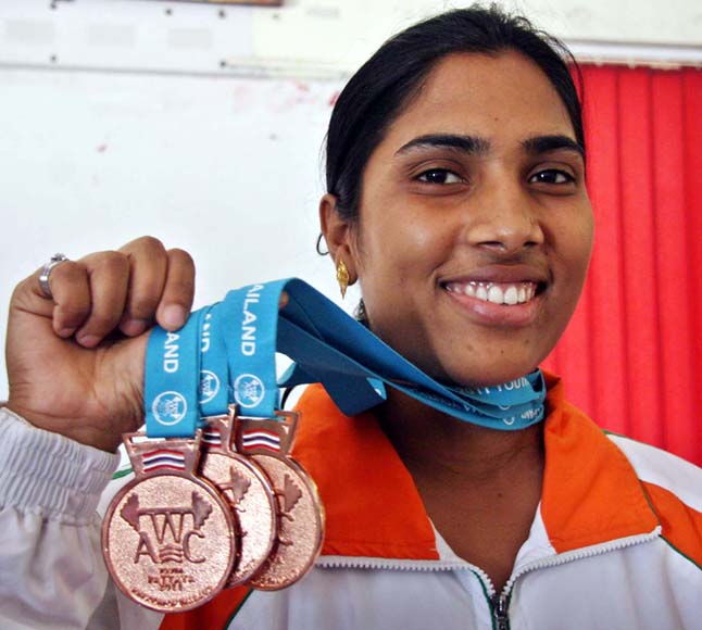 Odisha woman lifter Kiran Kumari Digal shows her Asian Youth bronze medals in Bhubaneswar on March 17, 2013.