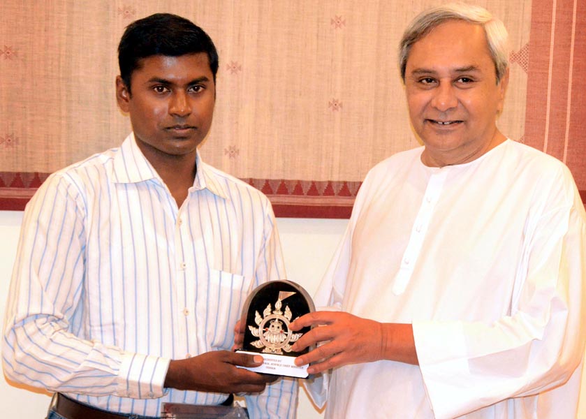 Chief Minister Naveen Patnaik felicitates mountaineer Yogabyasa Bhoi in Bhubaneswar on May 17, 2013.