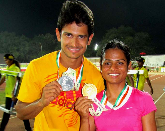 Odisha sprinters Amiaya Mallick (Left) and Dutee Chand show their National Games silver and gold medals in Kerala on February 11, 2015.