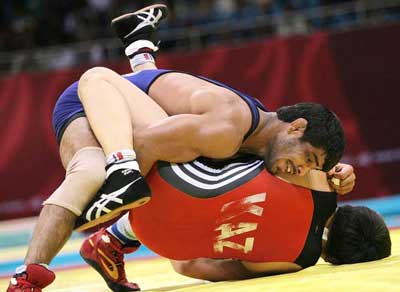 Indian wrestler Sushil Kumar tries to pin an opponent in Beijing Olympics on August, 2008.