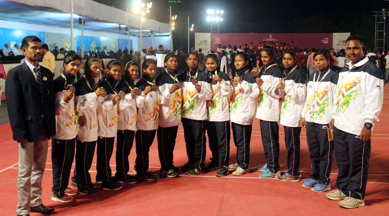 Players and officials of Odisha U-21 girls kho-kho team pose with their Khelo India Youth Games bronze medal in Pune on Jan 17, 2019.