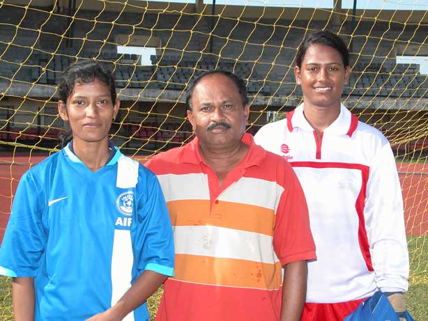 Woman football international Sradhanjali Samantaray with her coach Nanda Kishore Patnaik and India teammate Ranjita Mohanty at Kalinga Stadium in Bhubaneswar.