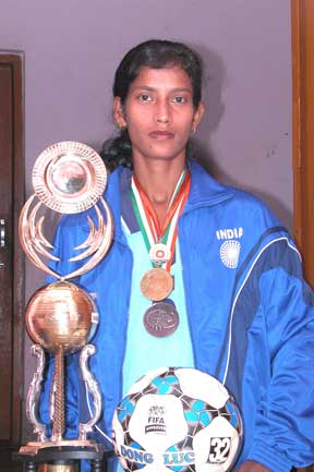 Star woman footballer Sradhanjali Samantaray with a trophy at her residence in Bhubaneswar.