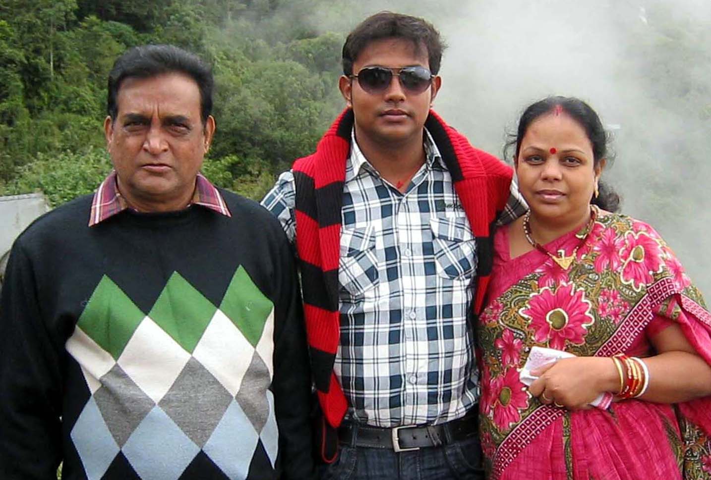 Undated file picture of Odisha footballer Asit Patra with his wife and son.