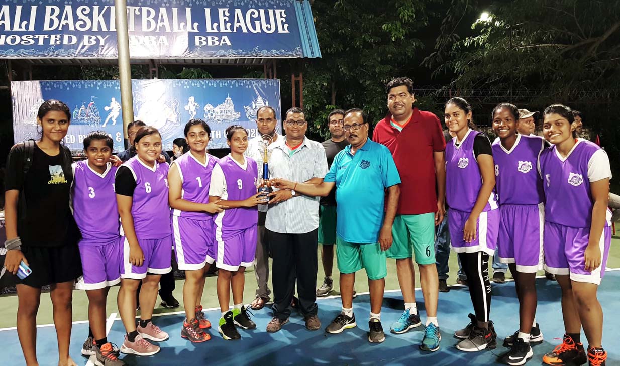 Players of Sikharchandi Shooters pose with the girls champion trophy at the Toshali Basketball League in Bhubaneswar on 10 October 2021.