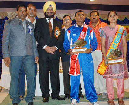  Indian Olympic Association General Secretary Raja Randhir Singh presents the `Strongman` and `Strongwoman` awards to Iswar Machhkund and Mandakini Mahanta at the 22nd State Powerlifting Championship in Bhubaneswar on Dec 8, 2008.