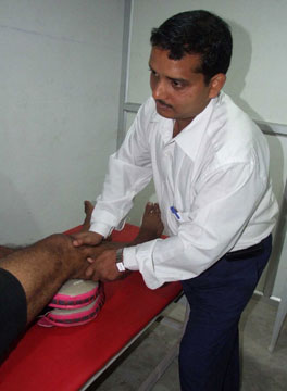 Professor Umasankar Mohanty treats an injured sportsperson in Bhubaneswar on 25th Dec. 2008