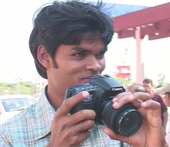 Hockey star <b>Prabodh Tirkey</b> taking a picture at the airport in Bhubaneswar on April 14, 2009.