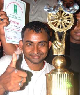 <b>Santosh Das </b>celebrates after winning the Champion of Champions Trophy in the Bhaina Memorial Arm Wrestling Tournament in Bhubaneswar on <b>June 20, 2009.