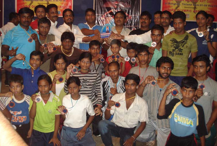 Orissa kickboxers pose with their East Zone trophy and medals in Bhubaneswar on <b>July 27, 2009.