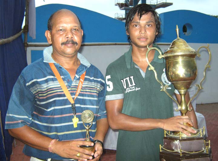Coach Surendra Kumar Naik (L) and his son Chintan Naik with their trophies in Bhubaneswar on June 7, 2010.