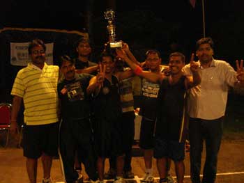 Players and officials of Buxi Basketball Association pose with the trophy after winning the Khurda District Basketball Tournament in Bhubaneswar on July 13, 2008.