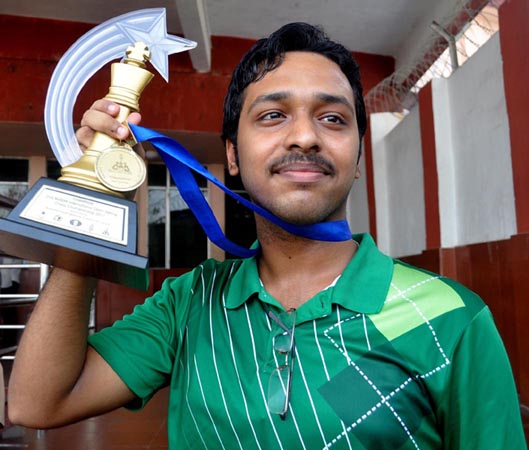 Anwesh Upadhya displays his Buddhi international trophy in Bhubaneswar on October 13, 2011.
