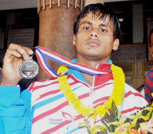 Orissa lifter Achyutananda Sahoo displays his Commonwealth medal in Bhubaneswar on October 19, 2011.
