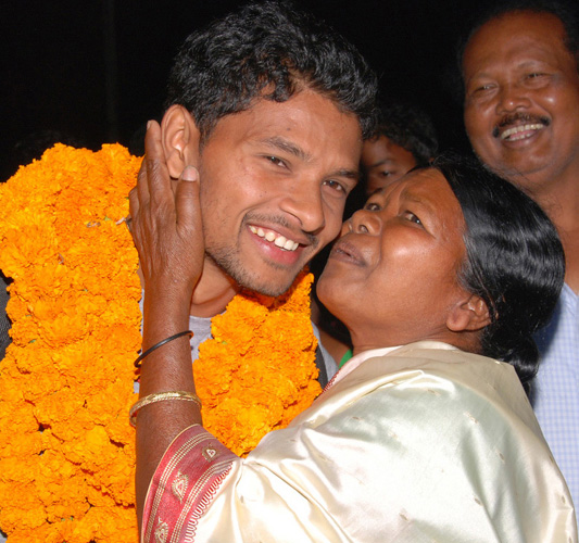 Odisha hockey international Birendra Lakra is hugged by his mother Merry in Rourkela on Feb 28, 2012.