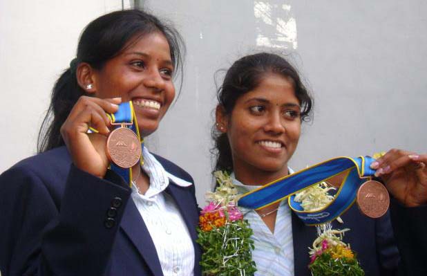 Orissa rowers Pratima Puhana (Right) and Pramila Prava Minz pose after winning bronze medal in the 16th Asian Games at Guangzhou on November 19, 2010.