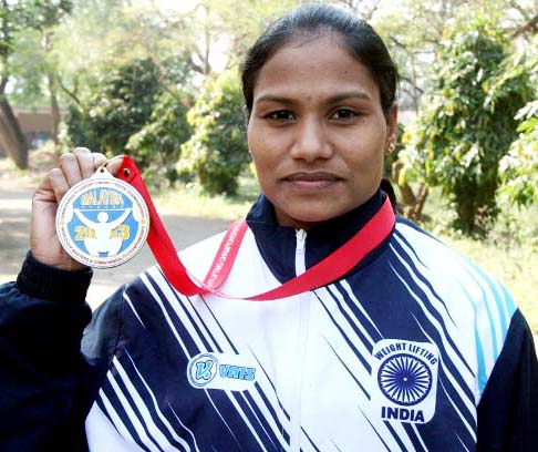 Odisha woman lifter Pramila Kirsani shows her Commonwealth medal in Bhubaneswar on December 2, 2013.