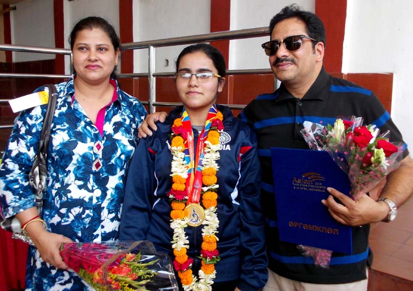 Odisha chess player Anwesh Mishra with her parents in Bhubaneswar on April 16, 2016.