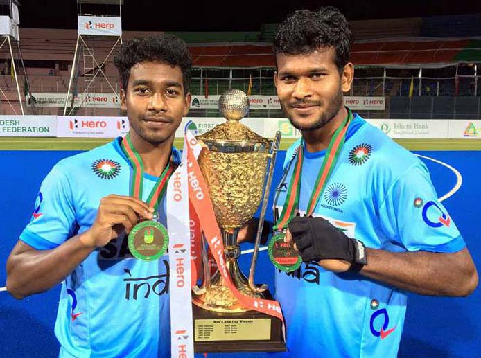 Odisha hockey stars Dipsan Tirkey and Amit Rohidas with the Asia Cup trophy in Dhaka on October 22, 2017.