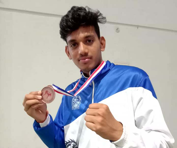 Odisha kickboxer Aditya Narayan Lenka with his All-India Inter-University bronze medal at Bhubaneswar on March 12, 2019.