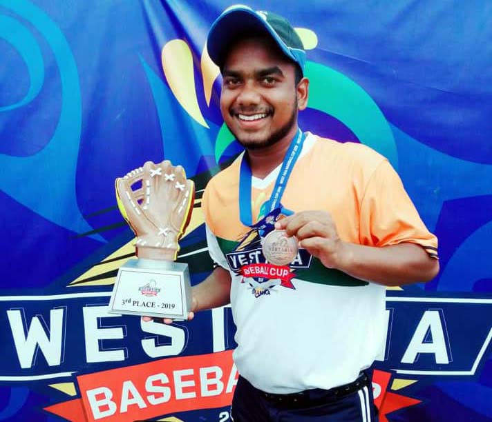 Odisha baseball international Padma Charan Hansdah with the bronze medal and trophy he received at the 14th West Asia Baseball Cup Tournament in Colombo in July, 2019.