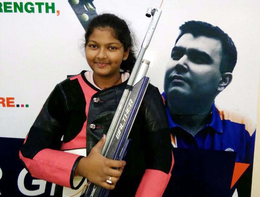 File photo of Bhubaneswar shooter Kashika Pradhan with the pic of Olympian Gagan Narang