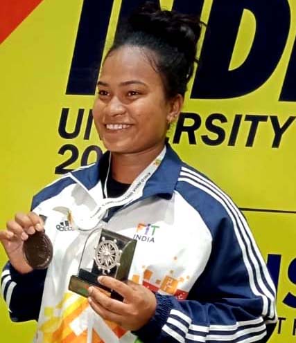 Odisha weightlifter Banita Ghadei with her Khelo India University Games bronze medal and memento in Bhubaneswar on 29 Feb, 2020.