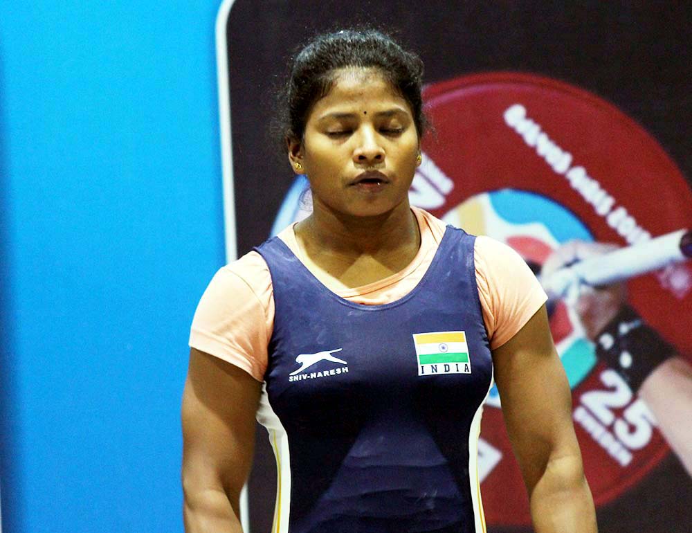 Undated file picture of Odisha weightlifter Sneha Soren concentrates before getting into action at an international competition.