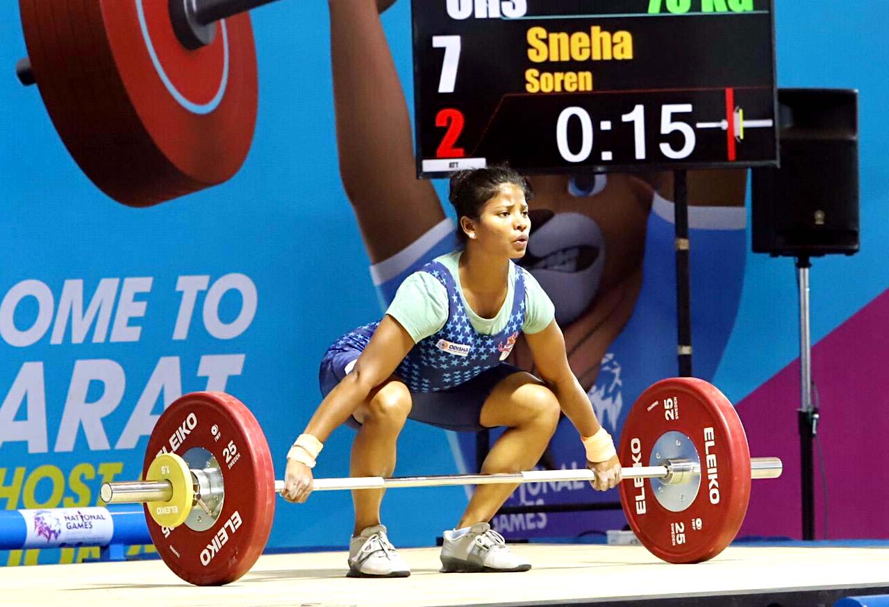 Odisha woman weightlifter Sneha Soren lifts on her way to bronze medal at the 36th National Games Gandhinagar, Gujarat on 30 September 2022.