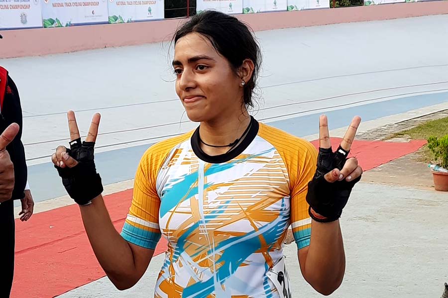 Odisha cycling queen Swasti Singh celebrates after winning a gold medal at the 74th Senior National Track Cycling Championship in Guwahati on 14 December 2022.