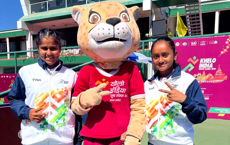 Odisha tennis players Sohini Mohanty (Left) and Aradhyaa Verma pose with Khelo India Youth Games mascot Asha after winning the girls doubles gold medal in Indore on 10 February 2023.