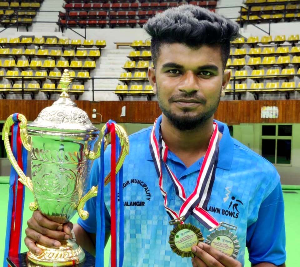 Odisha lawn bowling player Sourav Maharana poses with his medal and trophy at the 1st All-Odisha Inter-District Lawn Bowls Championship in Cuttack on 3 April 2023.