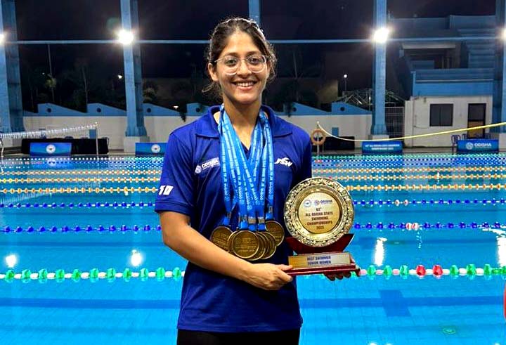 Odisha swimmer Shristi Upadhaya poses with her women individual champion trophy and medals at the 63rd State Swimming Championship in Bhubaneswar on 7 June 2023.
