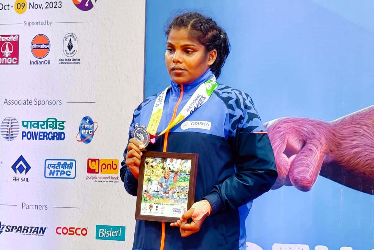 Odisha woman pencak silat player Plizalin Tarai poses with her silver medal at the 37th National Games in Panjim, Goa on 29 October 2023.