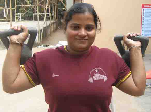 Orissa powerlifter Sangeeta Singh warms up with kettlebells in Bhubaneswar on Jan 15, 2009.