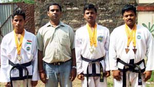 Taekwon-do medal winners with their coach (2nd from left) Manoranjan Patra in Bhubaneswar on May 25, 2008.