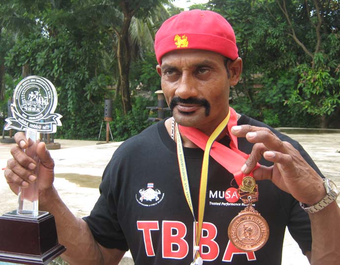 <b>Kartikeswar Jena </b> displays his Asian bodybuilding bronze medal and trophy in Bhubaneswar on <b>August, 21, 2009.