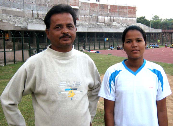 Orissa`s international woman footballer <b>Sasmita Mallick </b>with her coach <b>Bijay Kumar Kanugo</b> in Bhubaneswar on <b>Oct 24, 2009.