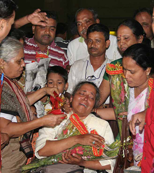 An ailing Kalpana Das is being greeted and consoled by her mother and family members on her returen home after a successful conquest of the Mount Everest, in Bhubaneswar on June 7, 2008.